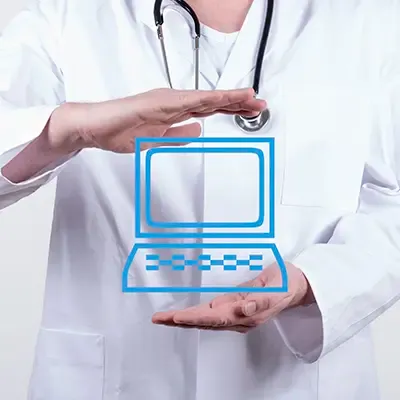 A doctor’s hands are clasping the drawn symbol of a computer