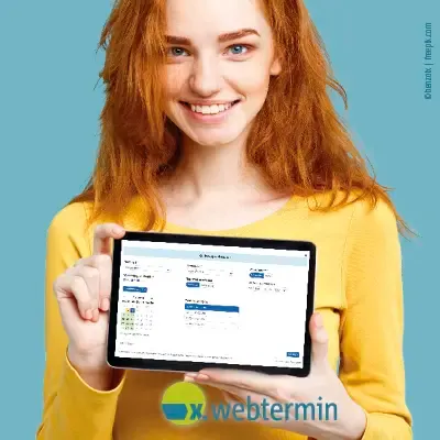 A young woman holds a tablet showing her appointment booking from x.webtermin up to the camera