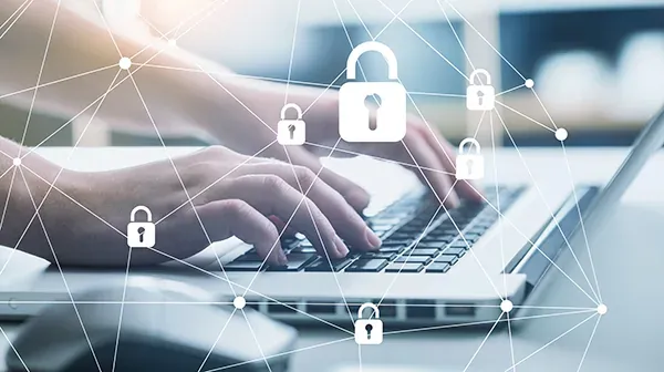Hands typing on a laptop keyboard, above them a network of white padlock icons